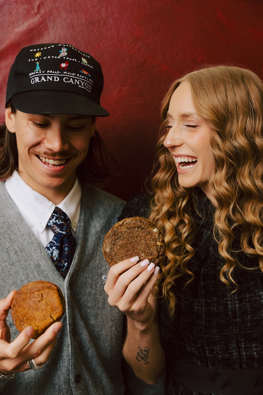 Two people laughing together as they share a Ring & Robe cookie