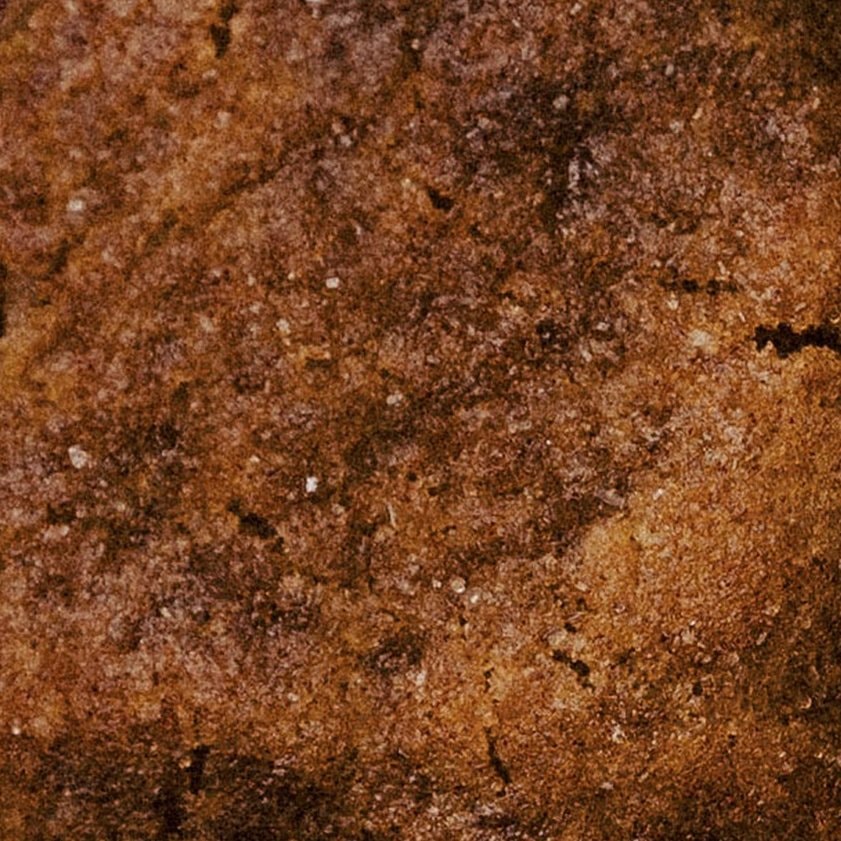 Macro crop of the Maverick cookie: a deep amber, sugar-flecked surface